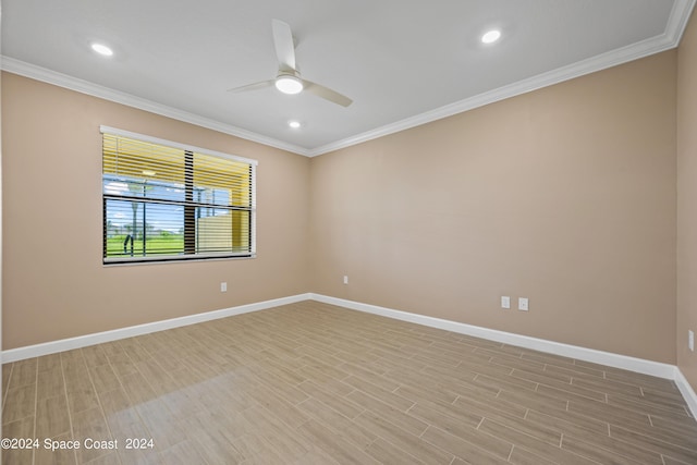 spare room with light wood-type flooring, baseboards, ornamental molding, and ceiling fan