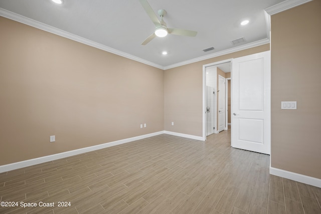 empty room featuring light wood-type flooring, ceiling fan, and crown molding