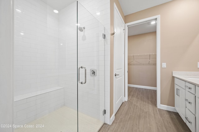 bathroom with vanity, hardwood / wood-style floors, and an enclosed shower