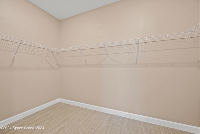 spacious closet with wood tiled floor