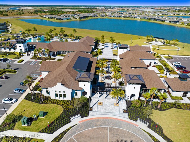 drone / aerial view with a water view and a residential view