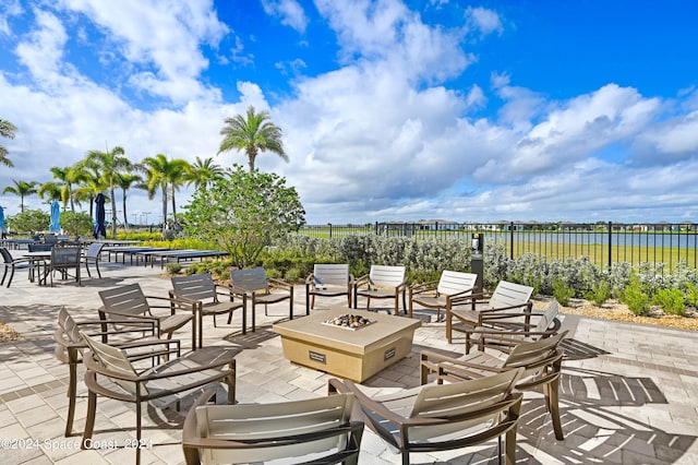 view of patio featuring a fire pit and a water view