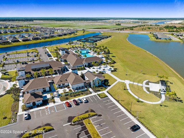 drone / aerial view featuring a residential view and a water view