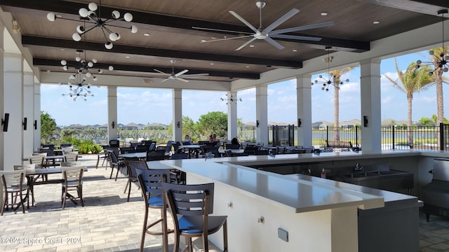 view of patio featuring fence and a bar