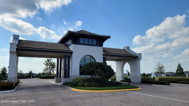 view of building exterior with uncovered parking