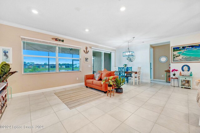 living room featuring crown molding, light tile patterned floors, and a chandelier