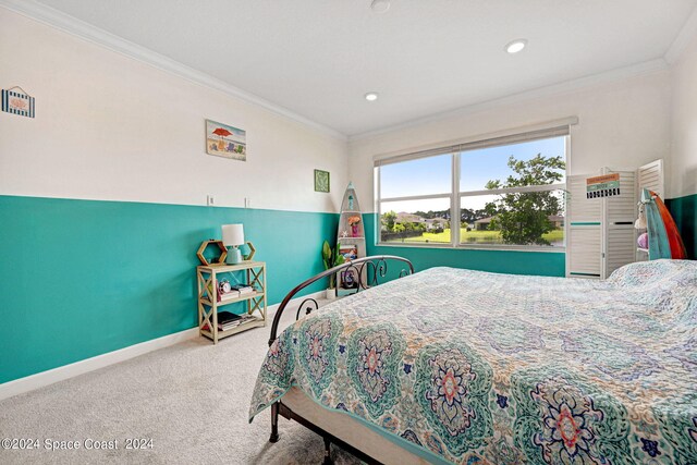 carpeted bedroom featuring crown molding