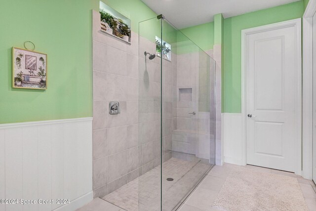 bathroom featuring tiled shower and tile patterned floors