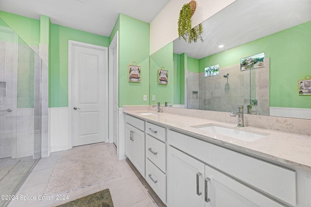 bathroom with vanity, tile patterned floors, and a shower with door