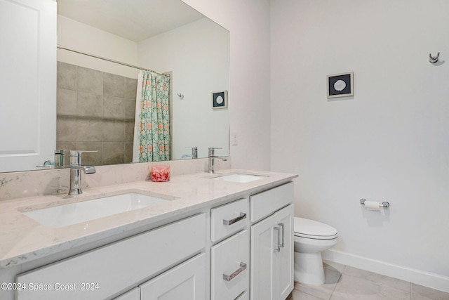 full bath with a sink, toilet, double vanity, and tile patterned flooring