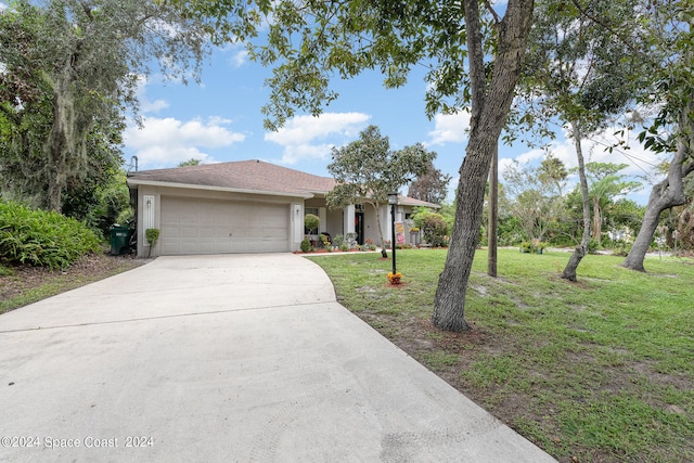 view of front facade with a garage and a front lawn