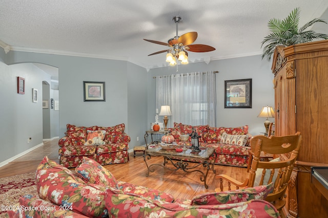 living room with a textured ceiling, crown molding, ceiling fan, and hardwood / wood-style flooring