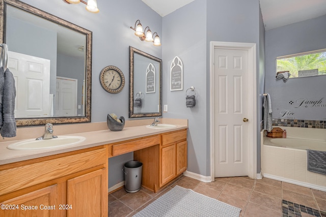 bathroom featuring vanity, tile patterned flooring, and a relaxing tiled tub