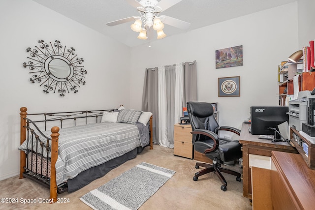 bedroom featuring ceiling fan, light colored carpet, and a textured ceiling