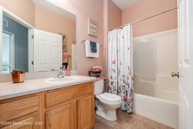 full bathroom with vanity, shower / bath combo with shower curtain, toilet, and tile patterned floors