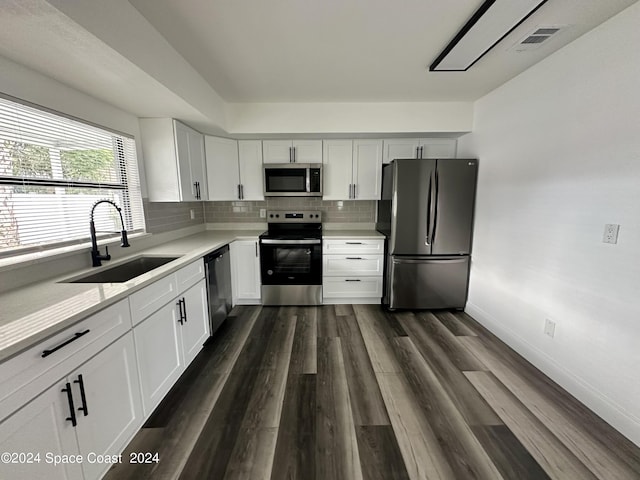 kitchen featuring backsplash, stainless steel appliances, sink, and dark hardwood / wood-style floors