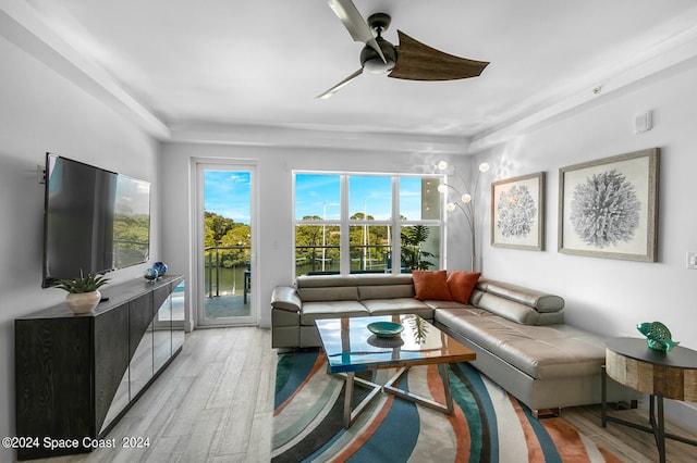 living room featuring ceiling fan and light hardwood / wood-style floors