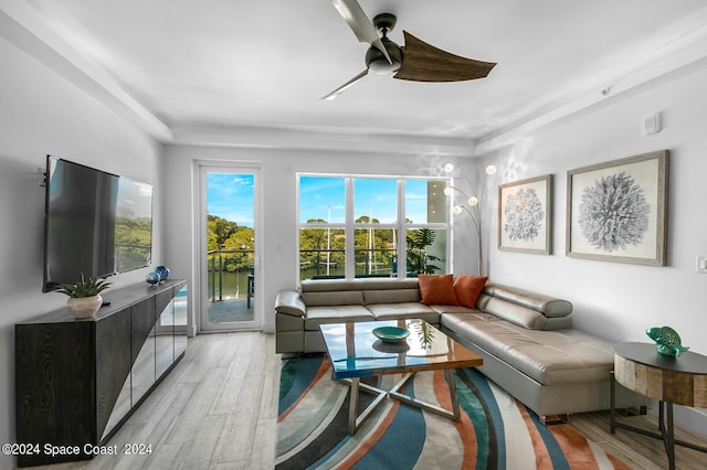 living room featuring light wood-style flooring and a ceiling fan