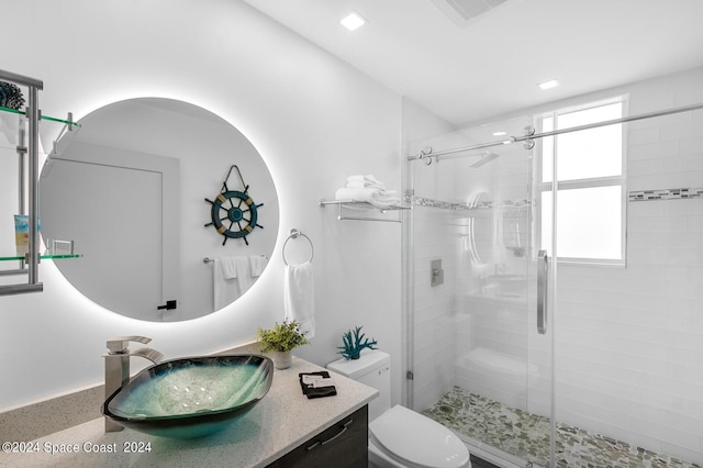 bathroom featuring a shower stall, visible vents, toilet, and vanity