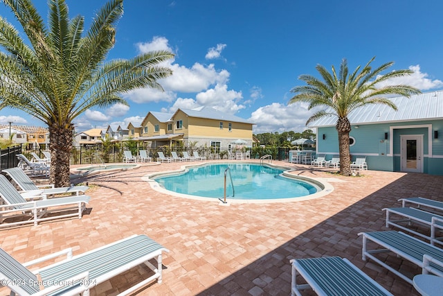 pool featuring fence and a patio area