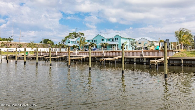 view of dock featuring a residential view and a water view