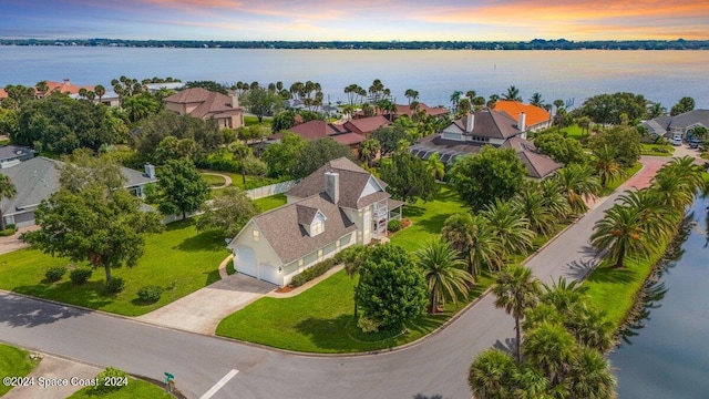 aerial view at dusk with a water view