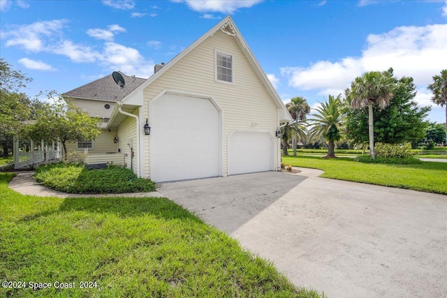 exterior space featuring a garage and a front lawn