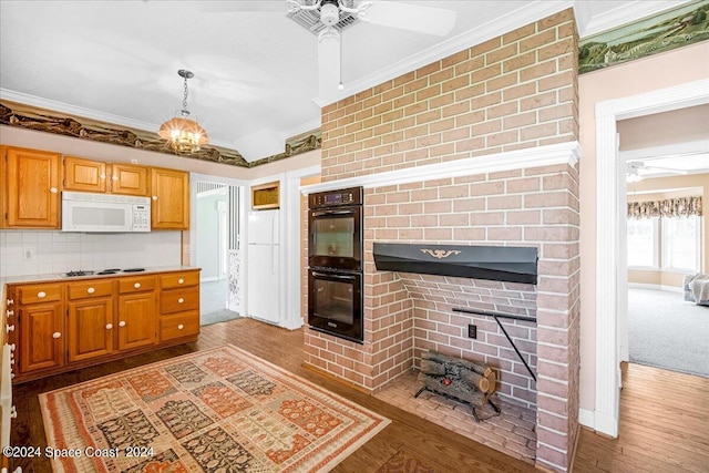 kitchen featuring crown molding, ceiling fan, white appliances, and light hardwood / wood-style floors