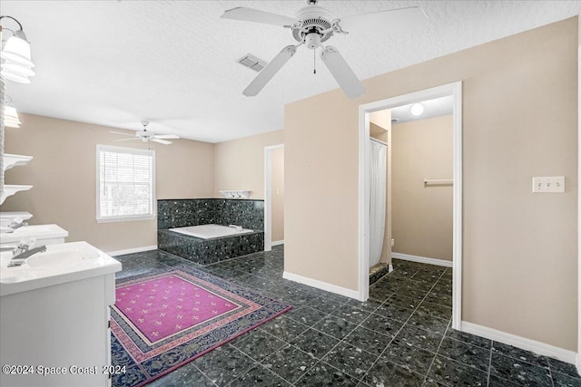 bathroom featuring toilet, a shower with curtain, vanity, ceiling fan, and a textured ceiling