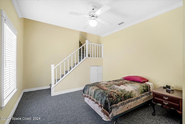 bedroom featuring dark carpet, ceiling fan, and crown molding