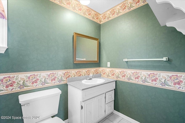 bathroom with vanity, toilet, and tile patterned floors