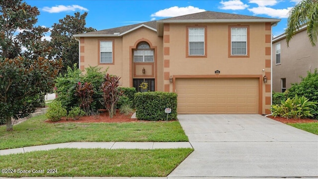 view of front of property with a garage and a front yard