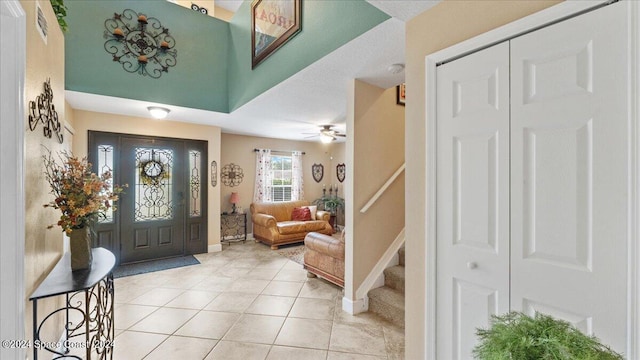 foyer featuring ceiling fan and light tile patterned flooring