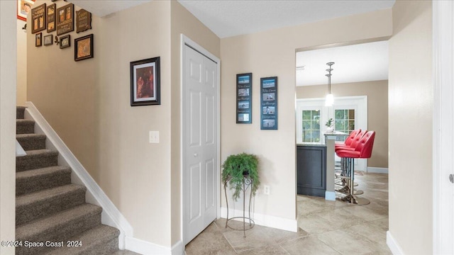 hallway with light tile patterned floors