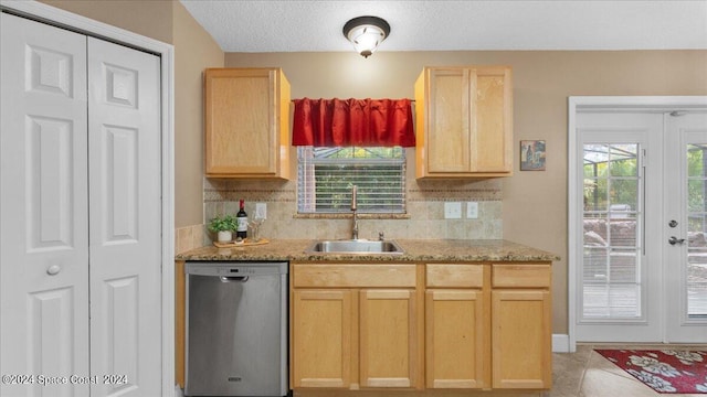 kitchen with dishwasher, light brown cabinetry, sink, and decorative backsplash