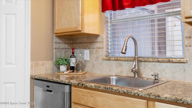 kitchen featuring dishwasher, sink, light brown cabinets, and decorative backsplash