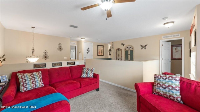 living room with ceiling fan and carpet