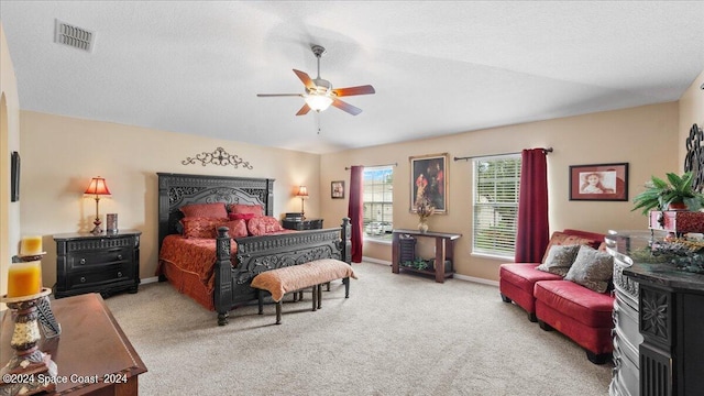 carpeted bedroom featuring a textured ceiling and ceiling fan