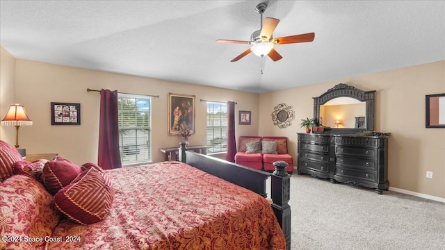 bedroom featuring a textured ceiling, ceiling fan, and carpet floors