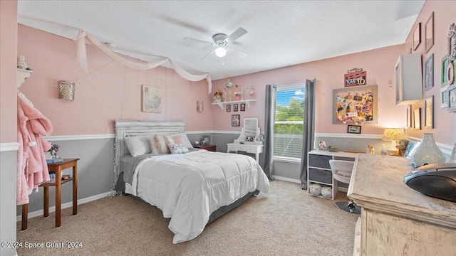 carpeted bedroom with a textured ceiling and ceiling fan