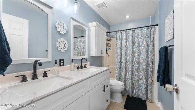 full bathroom featuring tile patterned flooring, toilet, shower / tub combo, vanity, and a textured ceiling