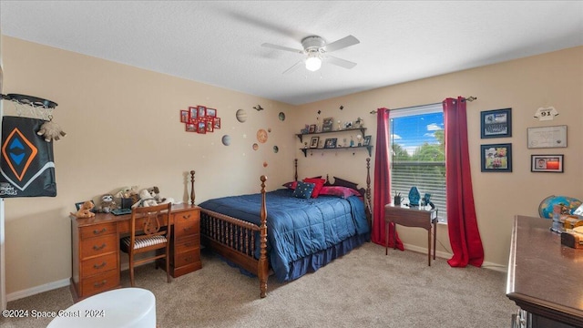 bedroom with ceiling fan, carpet, and a textured ceiling