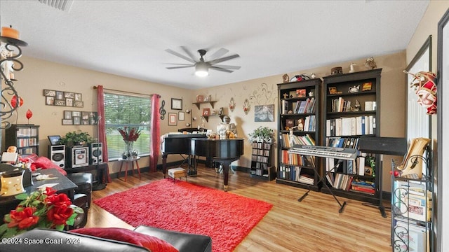 home office featuring a textured ceiling, light hardwood / wood-style flooring, and ceiling fan