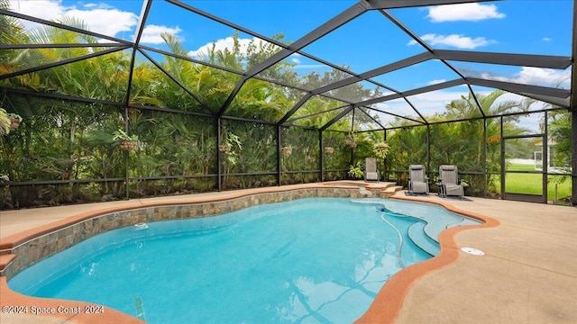 view of swimming pool with a lanai and a patio area