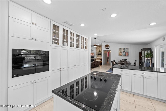 kitchen with black appliances, ceiling fan, white cabinets, and vaulted ceiling