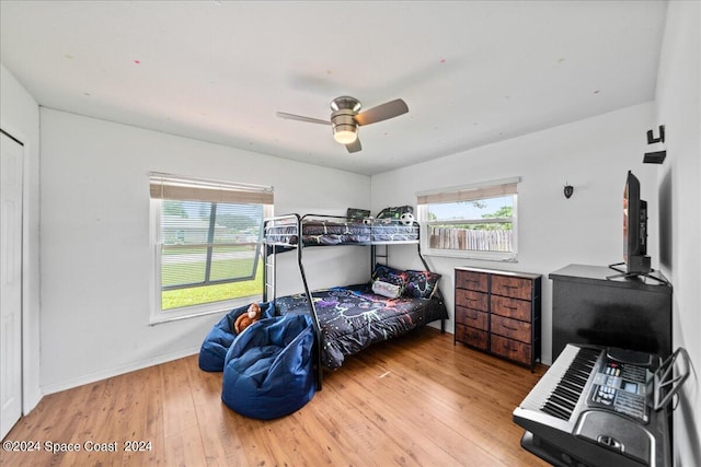 bedroom with ceiling fan and hardwood / wood-style floors