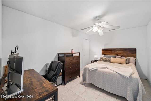 tiled bedroom with ceiling fan