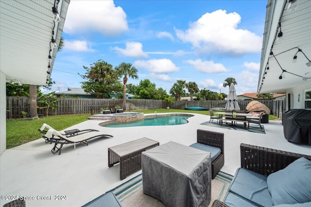 view of pool with an outdoor living space, an in ground hot tub, a lawn, and a patio