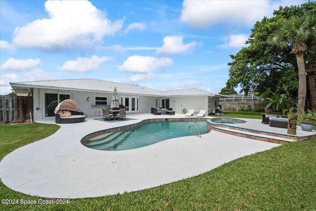 view of swimming pool featuring an in ground hot tub, a lawn, and a patio