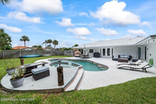 view of pool featuring an in ground hot tub, a patio, french doors, a yard, and outdoor lounge area